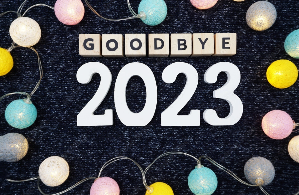 Goodbye 2023 alphabet letter decorate with led cotton ball on blue knitted fabric background